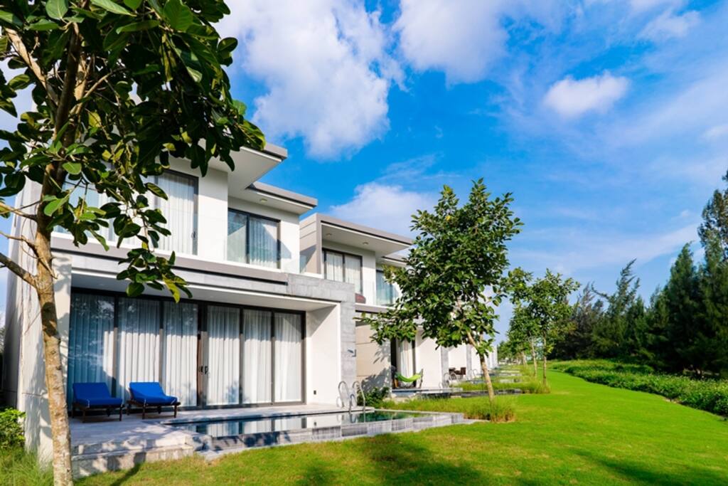 Private swimming pool with beautiful green garden at outside of the villa