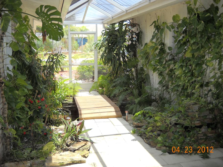 Front entrance with tropical garden and pond.