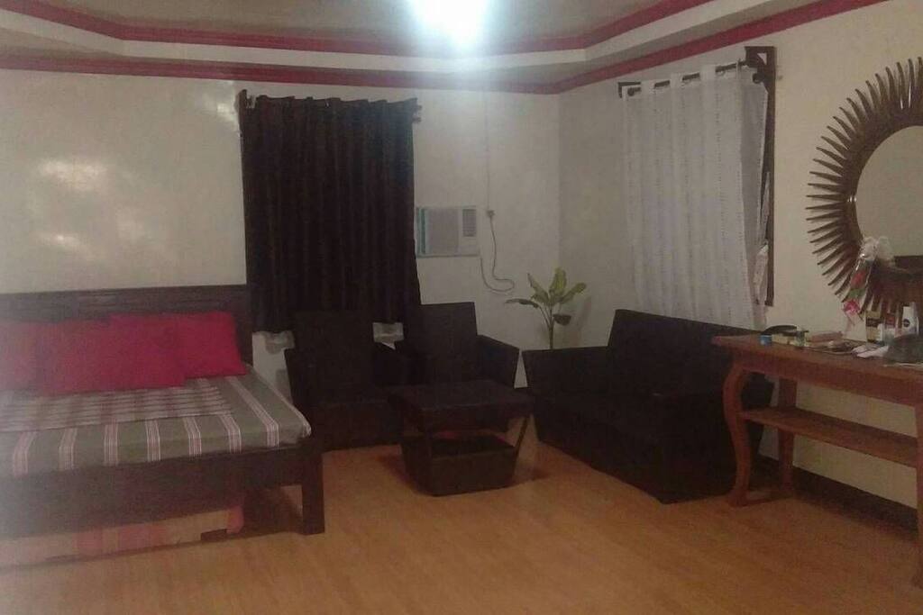 Air-conditioned room with queen size bed plus sofa & center table