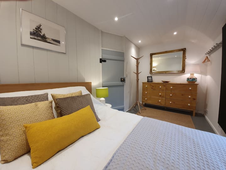 Large main bedroom has a huge king sized oak bed.