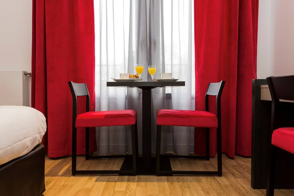 Sit down at the small dining table for a tasty meal.