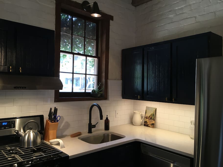 The kitchen is newly renovated and has quartz countertops and stainless appliances.