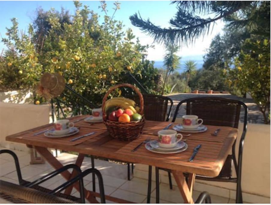 The house veranda (on the ground floor) - A lot of our guests prefer to eat at this table while enjoying the amazing sea view and the olive garden in front of the house as well. Our outdoors dining table seats comfortably 4 people. Some of our guests have even moved the table right in the middle of the olive garden!
