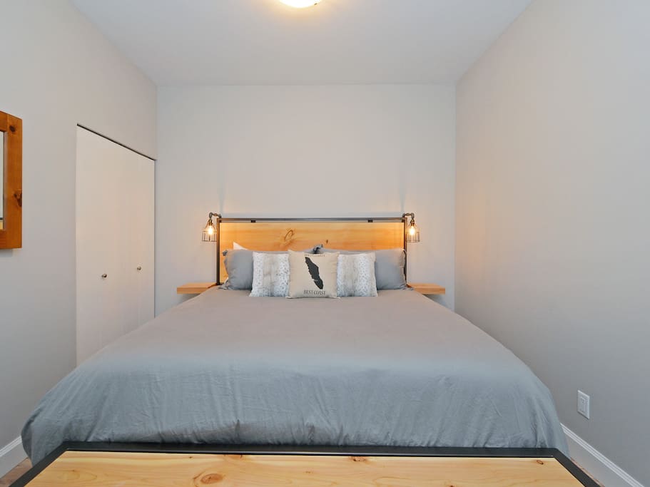 KING SIZE BED! Custom Douglas Fir slab headboard with cool industrial lighting.