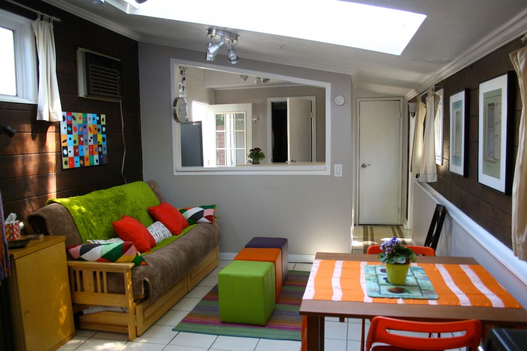 Front sitting room, with skylight, kitchen area, bath.