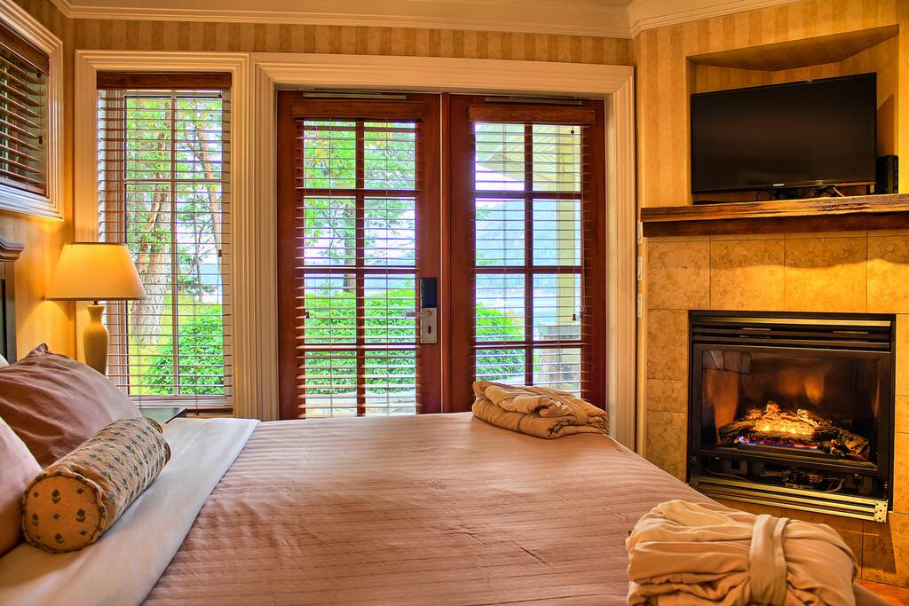 The master bedroom includes 1 king bed, 1 flat screen TV and a fireplace