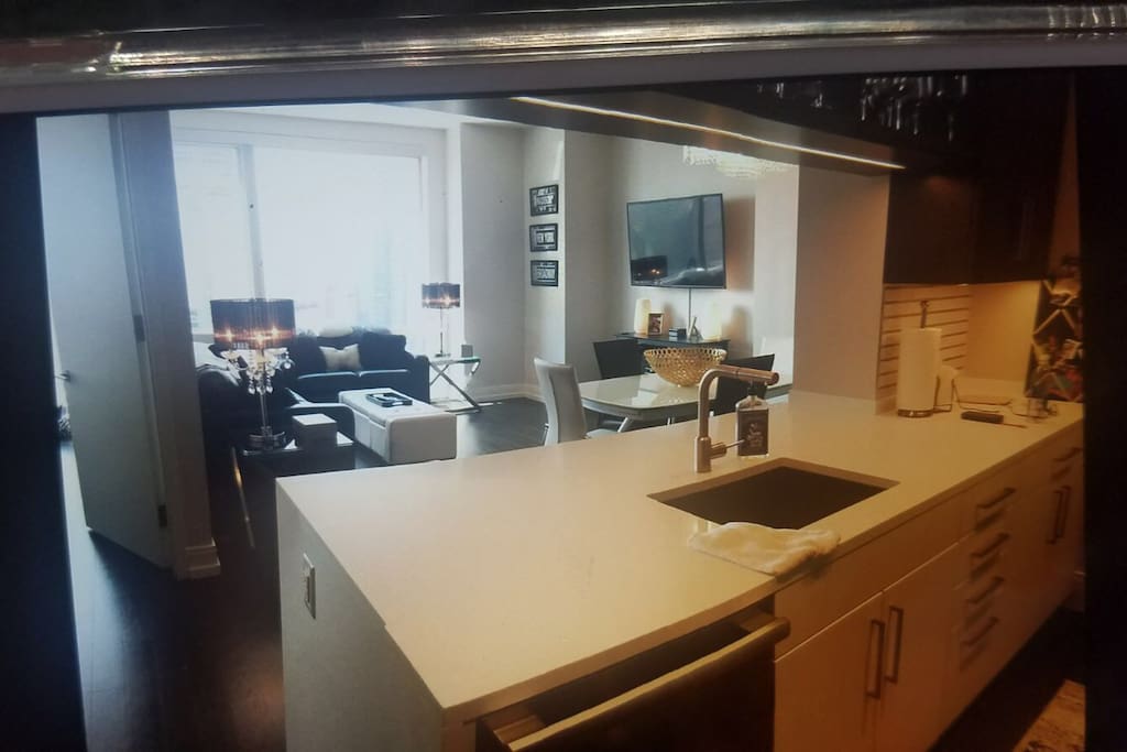 Kitchen counter has 3 stools and dining table that seats 6
