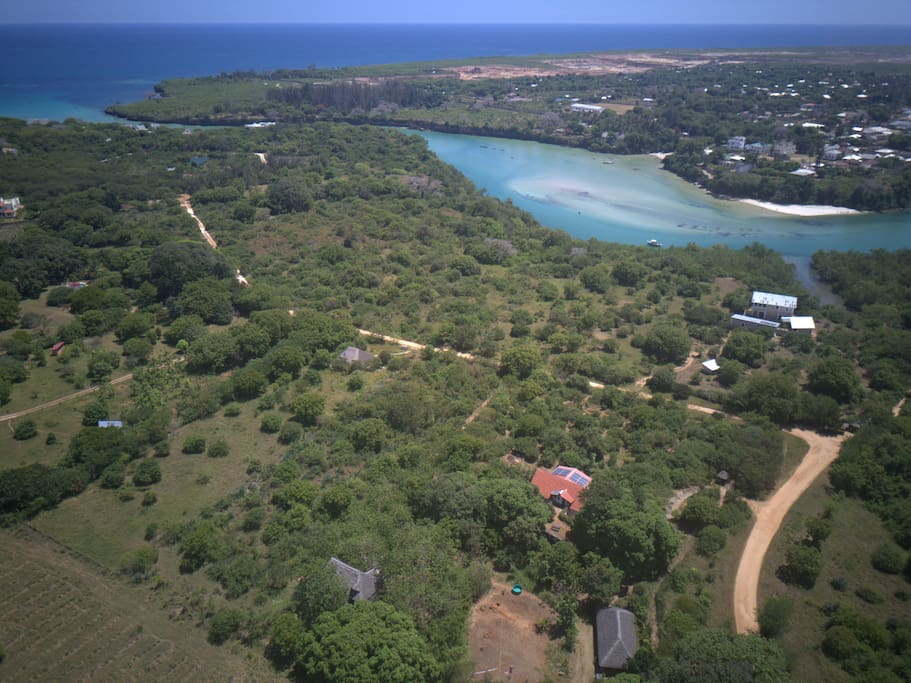 Our beautiful surroundings!
Mwembeni Eco House in the foreground with the clay tile roof and solar panels. Mwembeni Eco Tent just on lower edge of the photo.