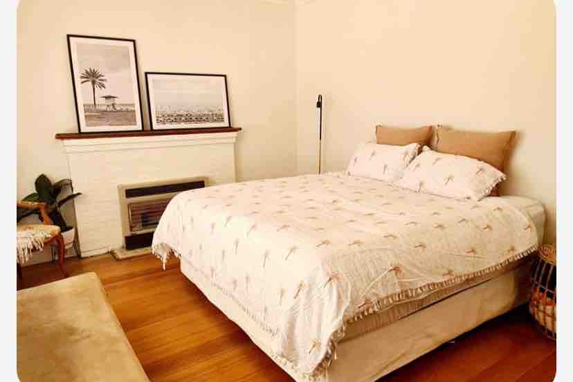 Hermoso dormitorio  con vistas a una hermosa calle arbolada.