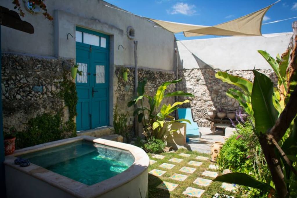 A full view of the dipping pool, terrace and street side entrance to the property.