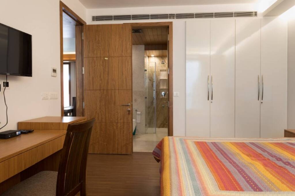Washroom attached with shower cubicle on the far right inside.