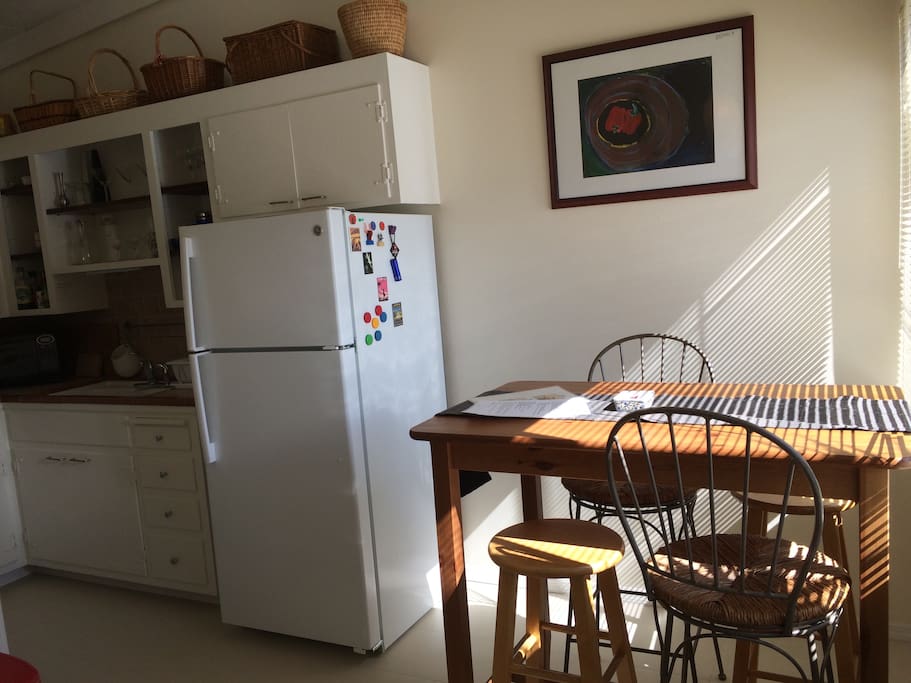 Eat-in kitchen with seating for 4. Full-size fridge.