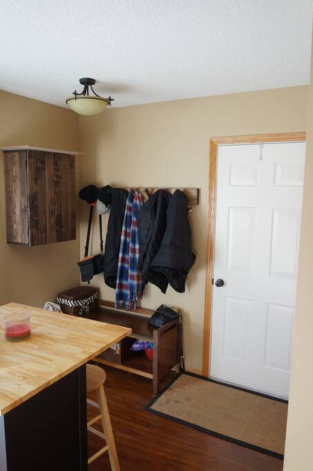 The garage entry and island with barstools