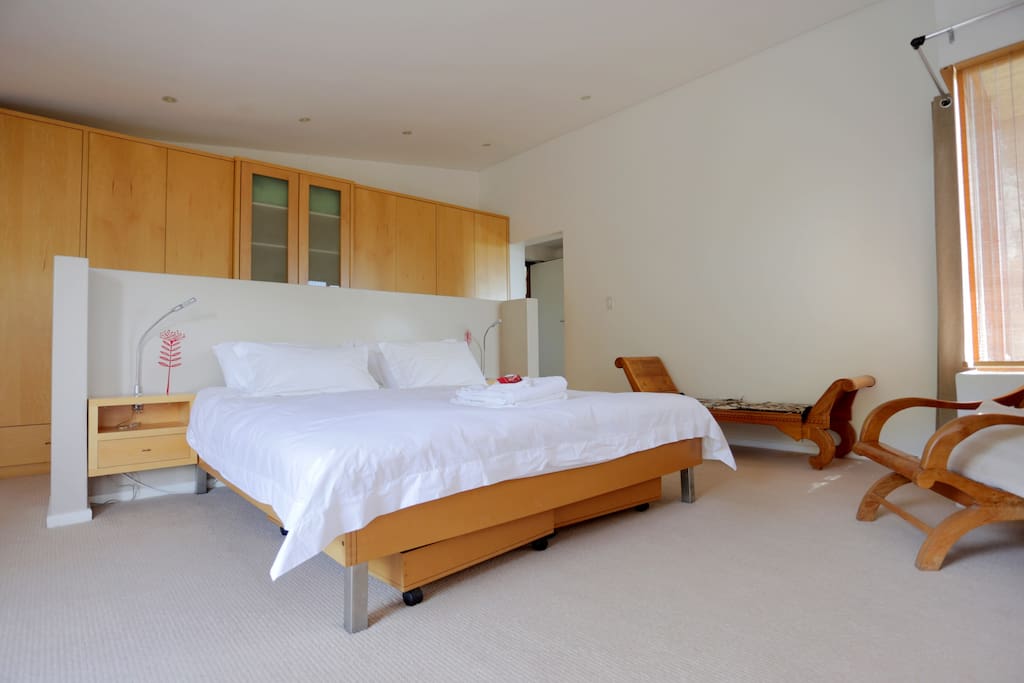 Master bedroom with King size bed opening onto private balcony with stunning views of the mountains and beach