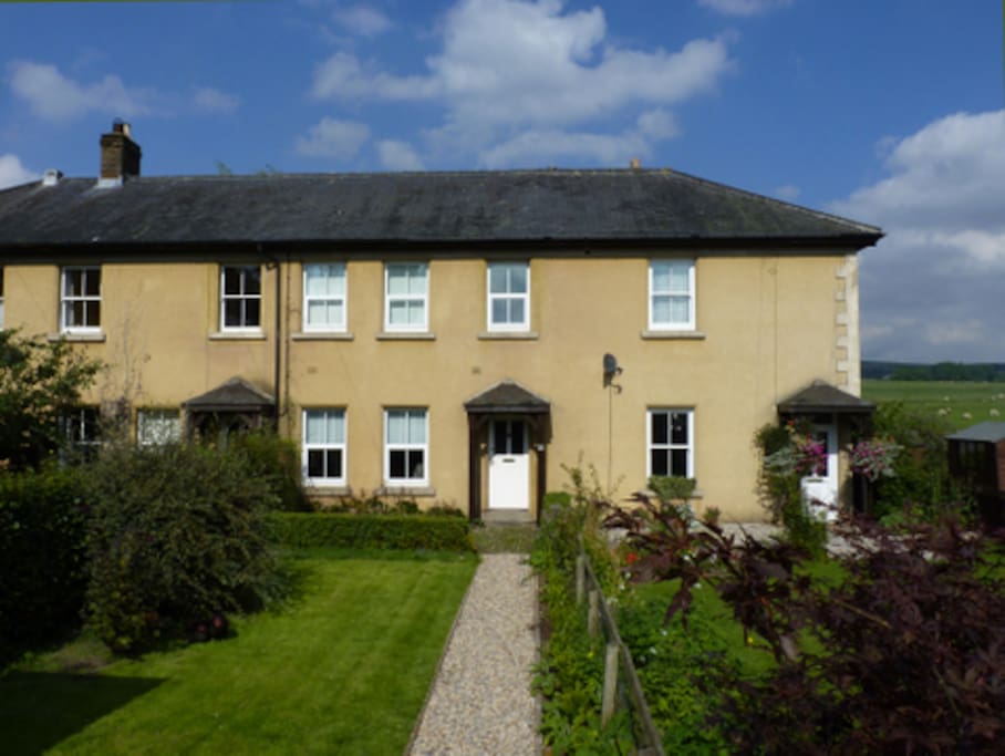 The cottage is in a terrace with three other houses.