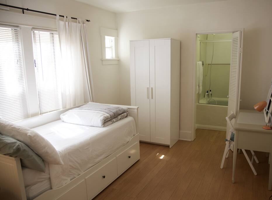 Large wardrobe, efficient work space, and and shower/tub.