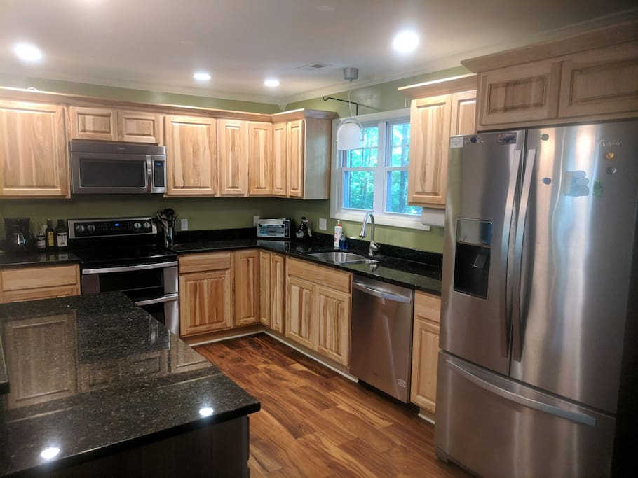 Fully stocked gourmet kitchen with plenty of counter space including a large island.