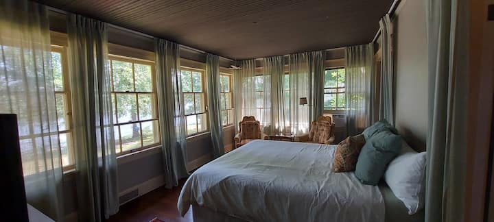 The Sun Suite

The bedroom has a full wall of windows facing the river, bathroom with shower/tub, a walk-in closet, and California king memory foam mattress. 
The boho aesthetic gives this space a soothing vibe that invites you to relax.
