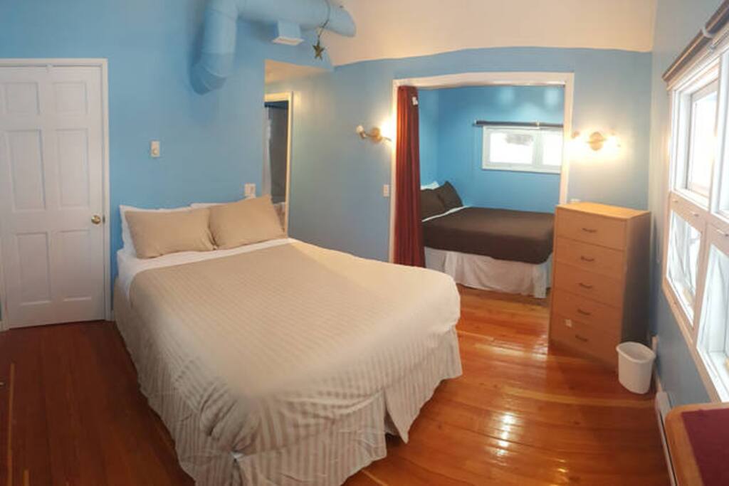2 queen beds in the master room with privacy curtain