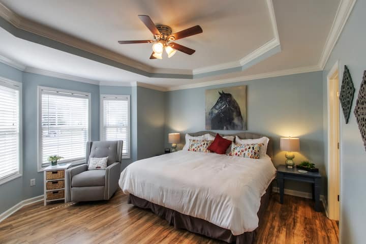 A restful master retreat with swivel rocker tucked into bay window area. 