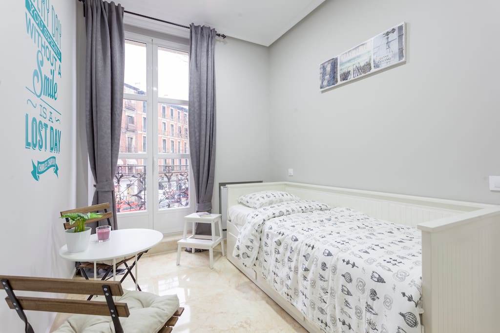 Light-filled bed room with balcony