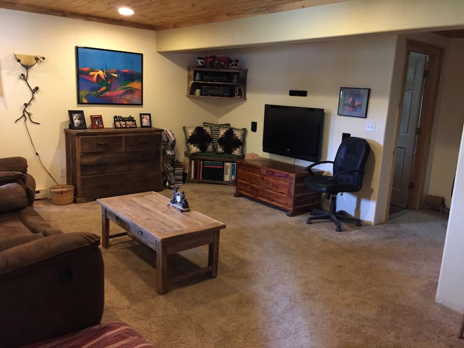 Downstairs living area/bedroom. It has a queen-size Murphy bed. Full bathroom is to the far right.