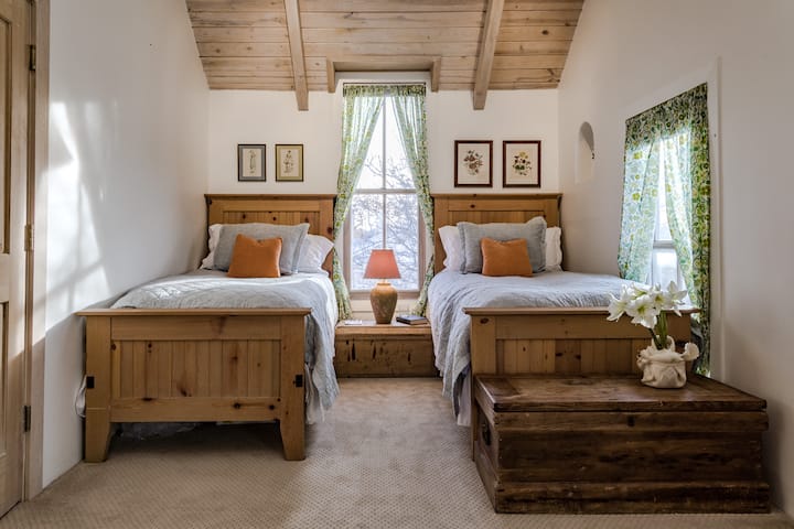 Second bedroom, also upstairs, features two comfortable single beds with lovely linens. 