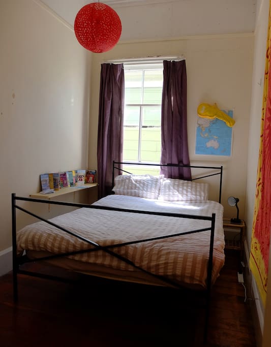 Comfy queen bed with good afternoon light.
