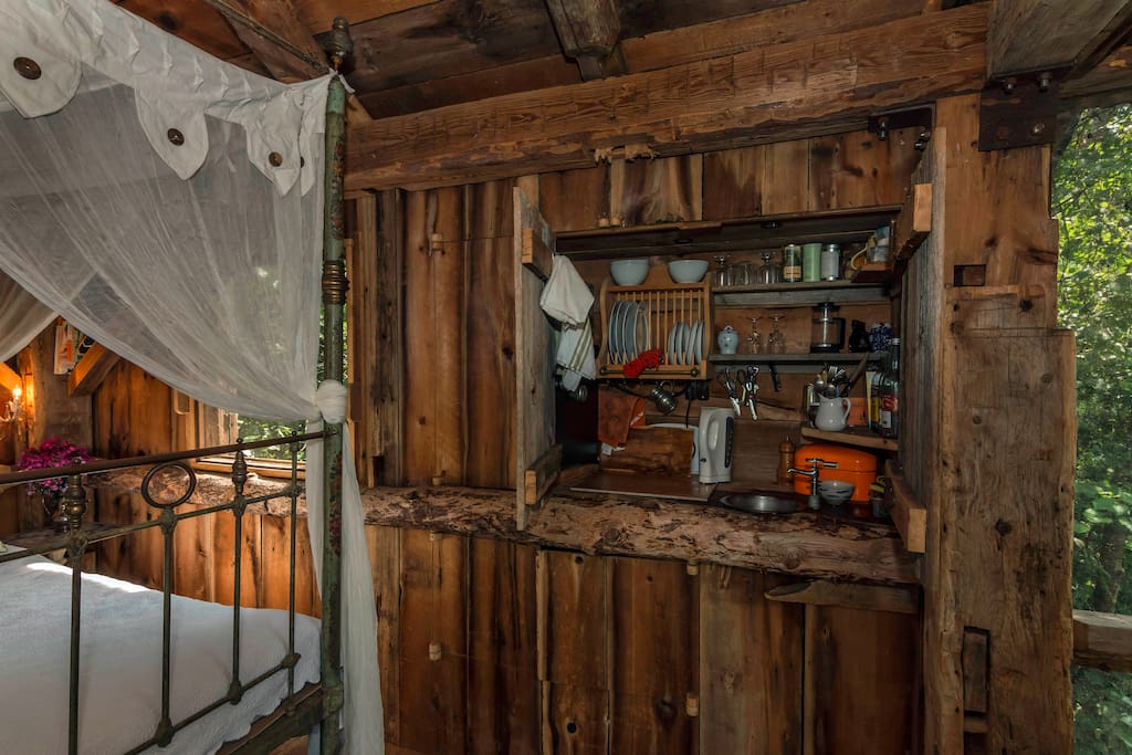 Secreted behind the wood hinged door is your tiny kitchen