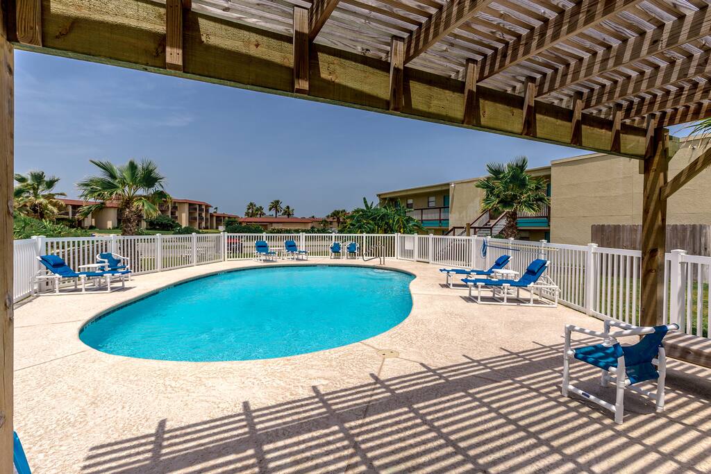 Find shade under the awning and plenty of sun on a poolside lounger at the shared pool.