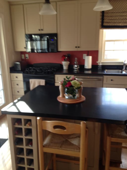 This sunny, fully equipped kitchen with GE appliances, is a great space that opens into the family room so you can cook and converse with friends. The French doors leading out to the patio is a wonderful place to enjoy a cup of coffee or cocktail.