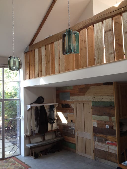 Double-height entrance area with period Fontana central lighting.