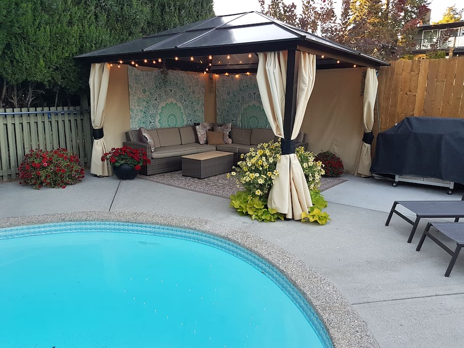 Poolside cabana complete with comfy couches and loungers