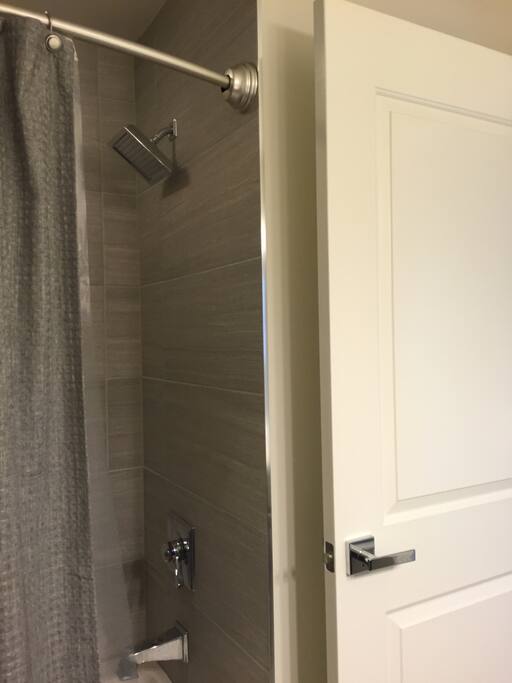 New tiled bath with oversized shower head