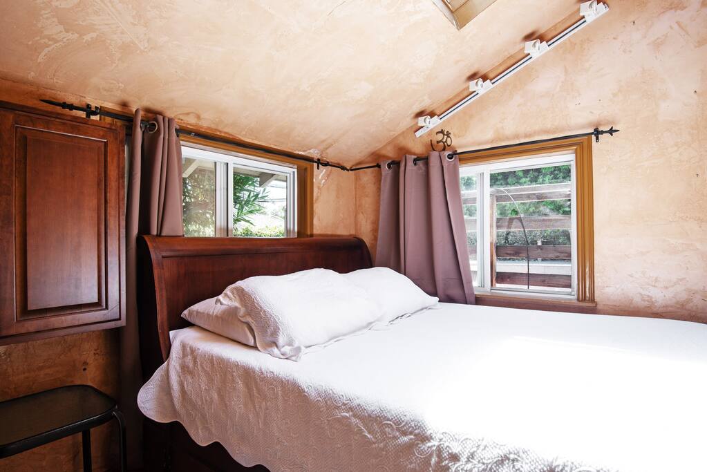 The queen size bed on the platform.