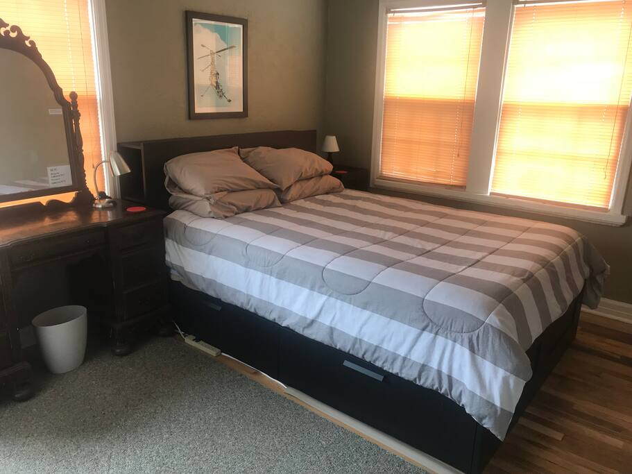Comfy bed with 4 pillows, lamps and power strips on each side