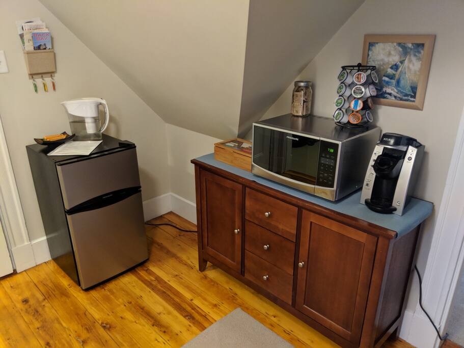 Fridge, microwave, tea, and coffee maker, with chest storing a toaster and electric kettle