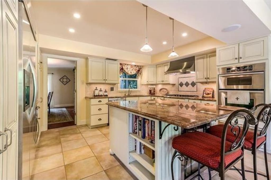 Fully equipped eat in kitchen with easy access to large in ground pool.
