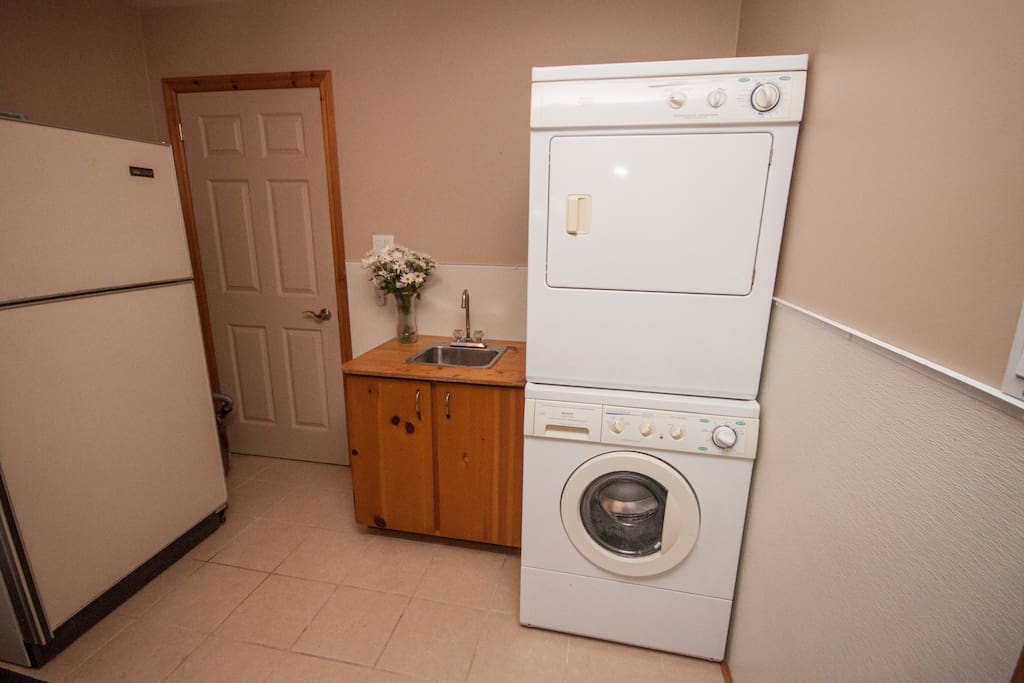 Laundry & mud room with extra fridge.