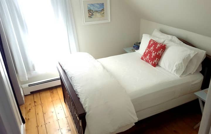 Peaceful double room with closet, blackout drapes, and ceiling fan