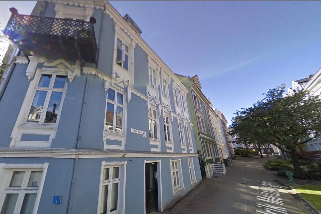 The house from the street. Your apartment is on the same level as the balcony facing the tree lined street.
