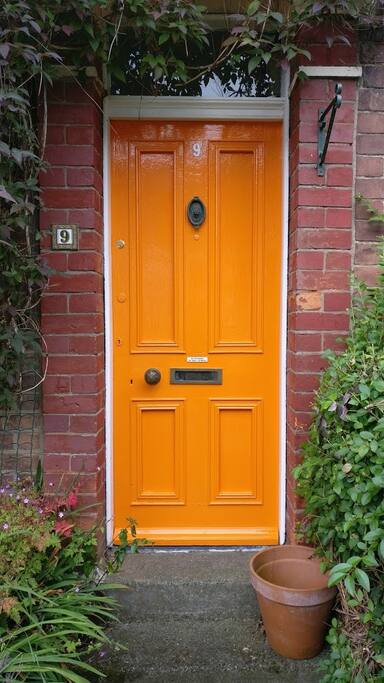 You can't really miss the front door - it's the only orange one in the street!