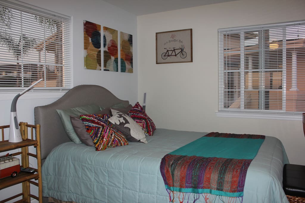 New queen-size bed for up to two adults; light/fan combos are located at the edge of each side.