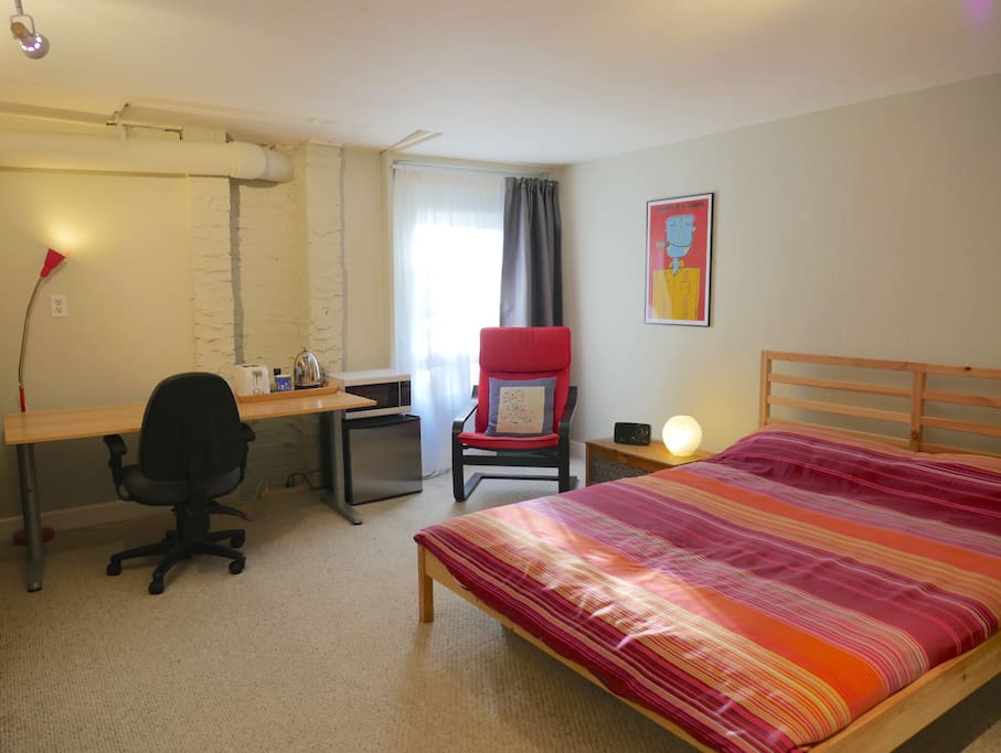 Plenty of room for the queen bed, comfy chair, desk, fridge and microwave