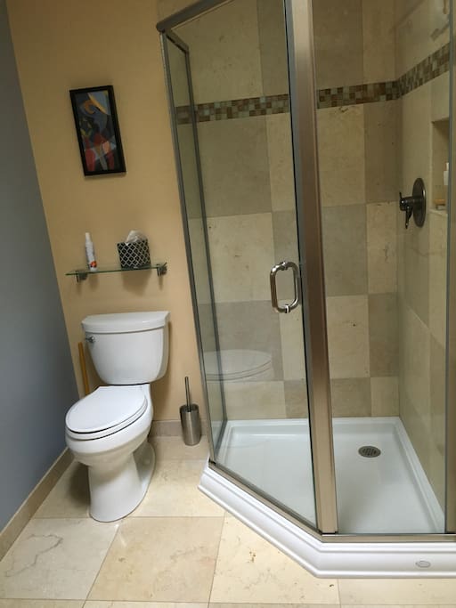 Private bathroom with stone tile in shower and on floor