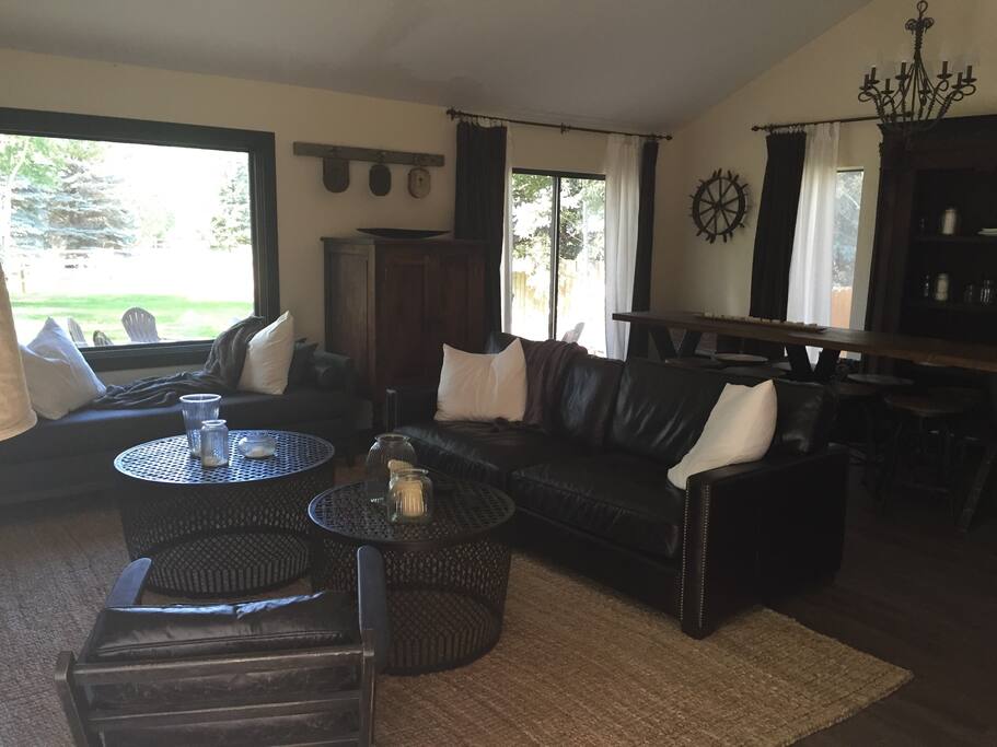Open concept living room with views of ski resorts.