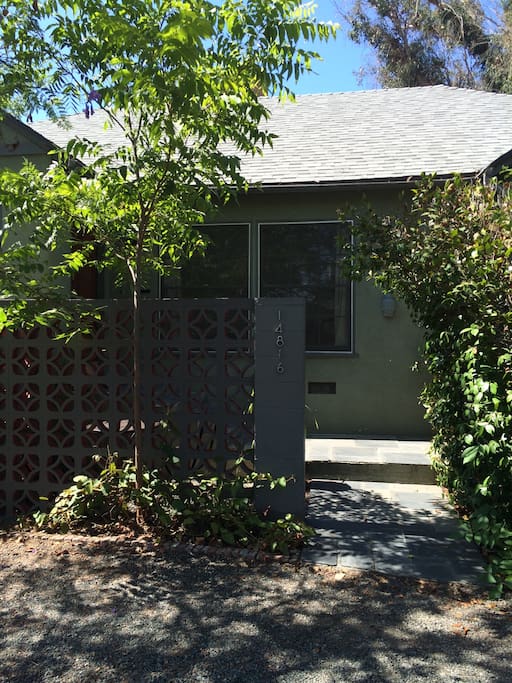 Entrance to house, with gravel driveway.
