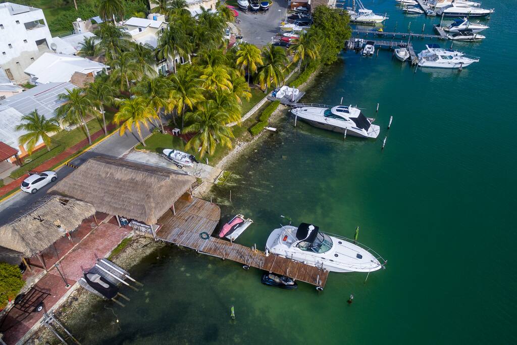 Dock, lagoon front, parking space and home entrance.