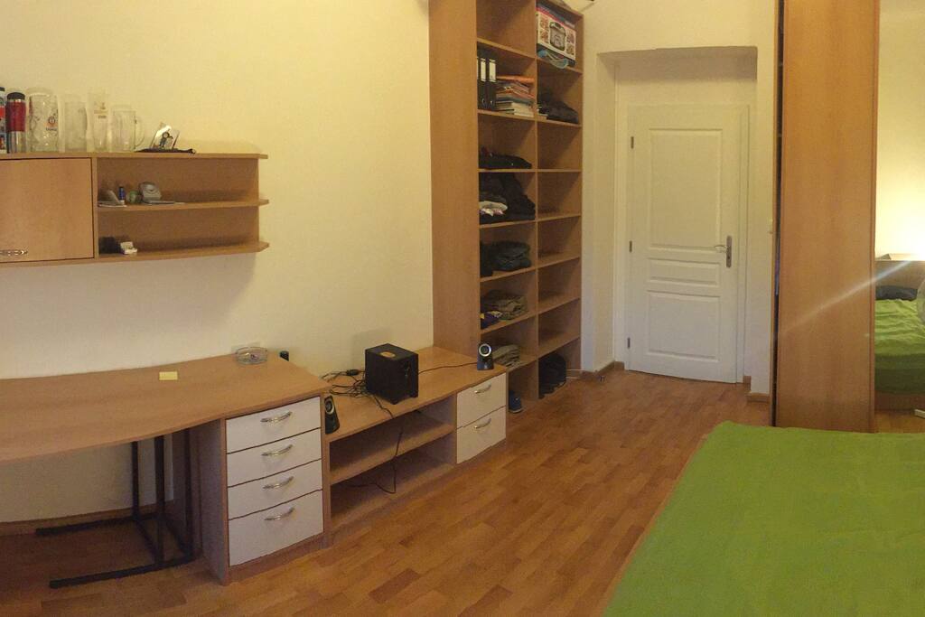 The opposite angle of the bedroom giving you a better look at the shelves and closet.