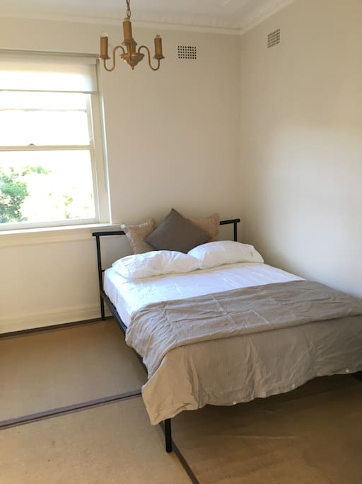 There is a wardrobe at the foot of the bed and a hanging rail to the left.